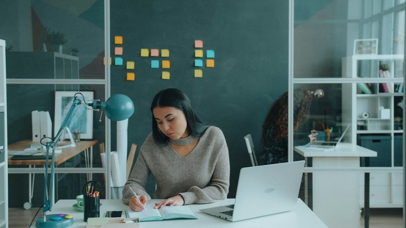 An executive working through plans at her desk
