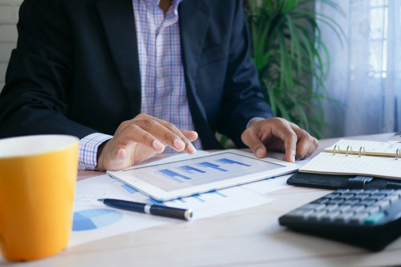 An executive reviewing financial charts on a tablet